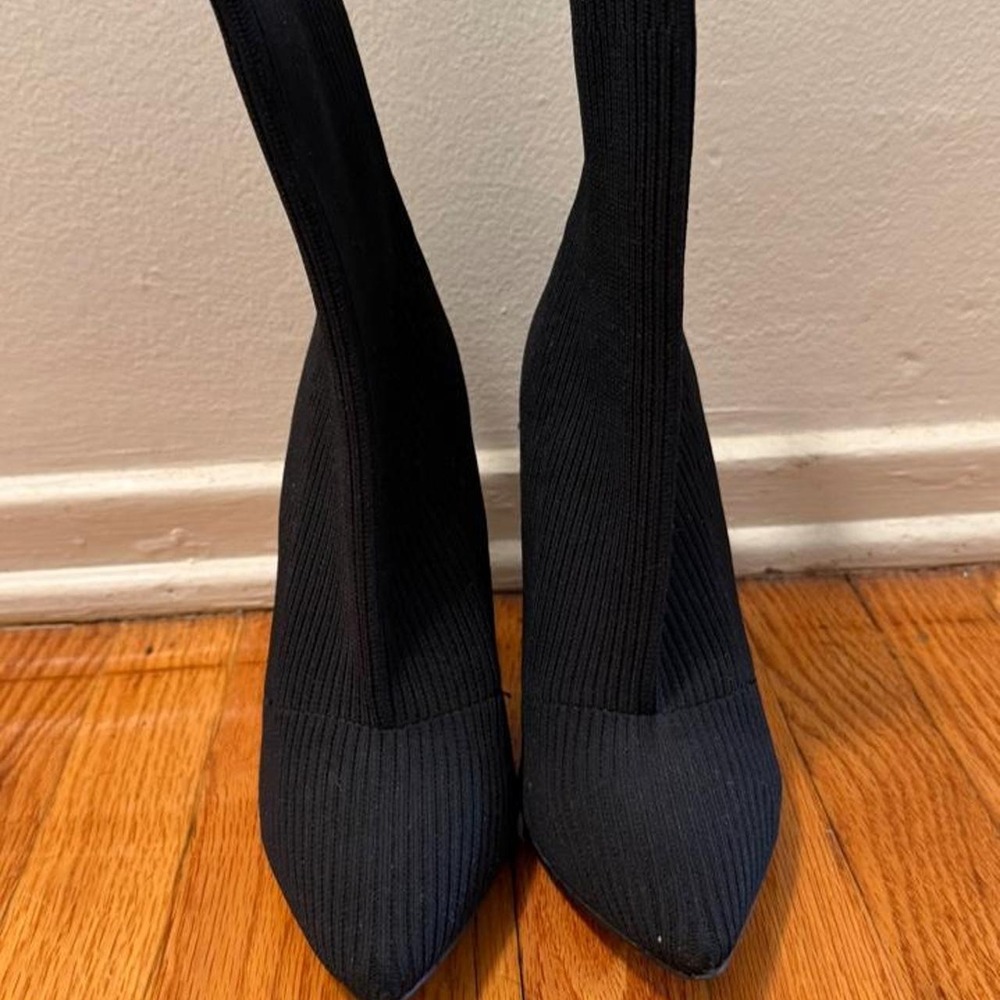 Black ribbed knit ankle boots with pointed toe